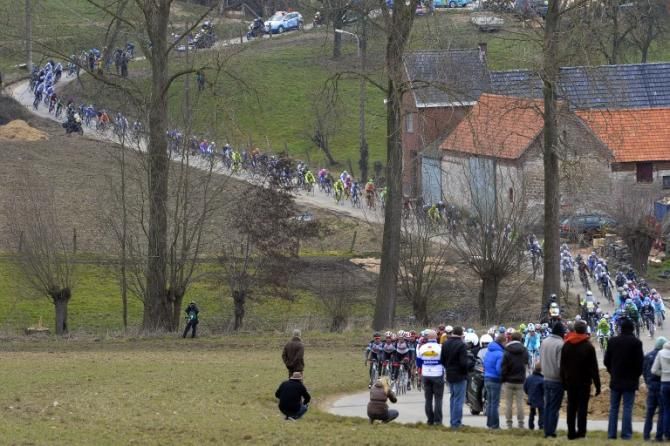 The peloton stretched out on the narrow roads of the Tour of Flanders parcours.