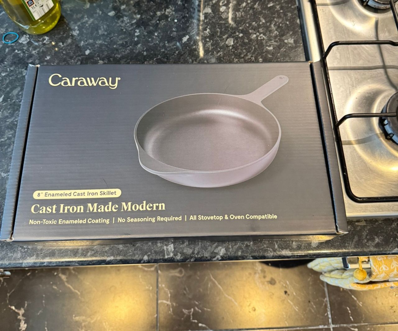 The Caraway black cast iron skillet box on a kitchen counter.