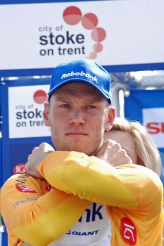Lars Boom pulls on the leader’s yellow jersey