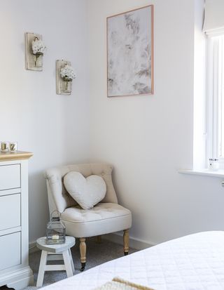 bedroom with white walls and armchair