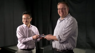 Two men holding a game in their hands