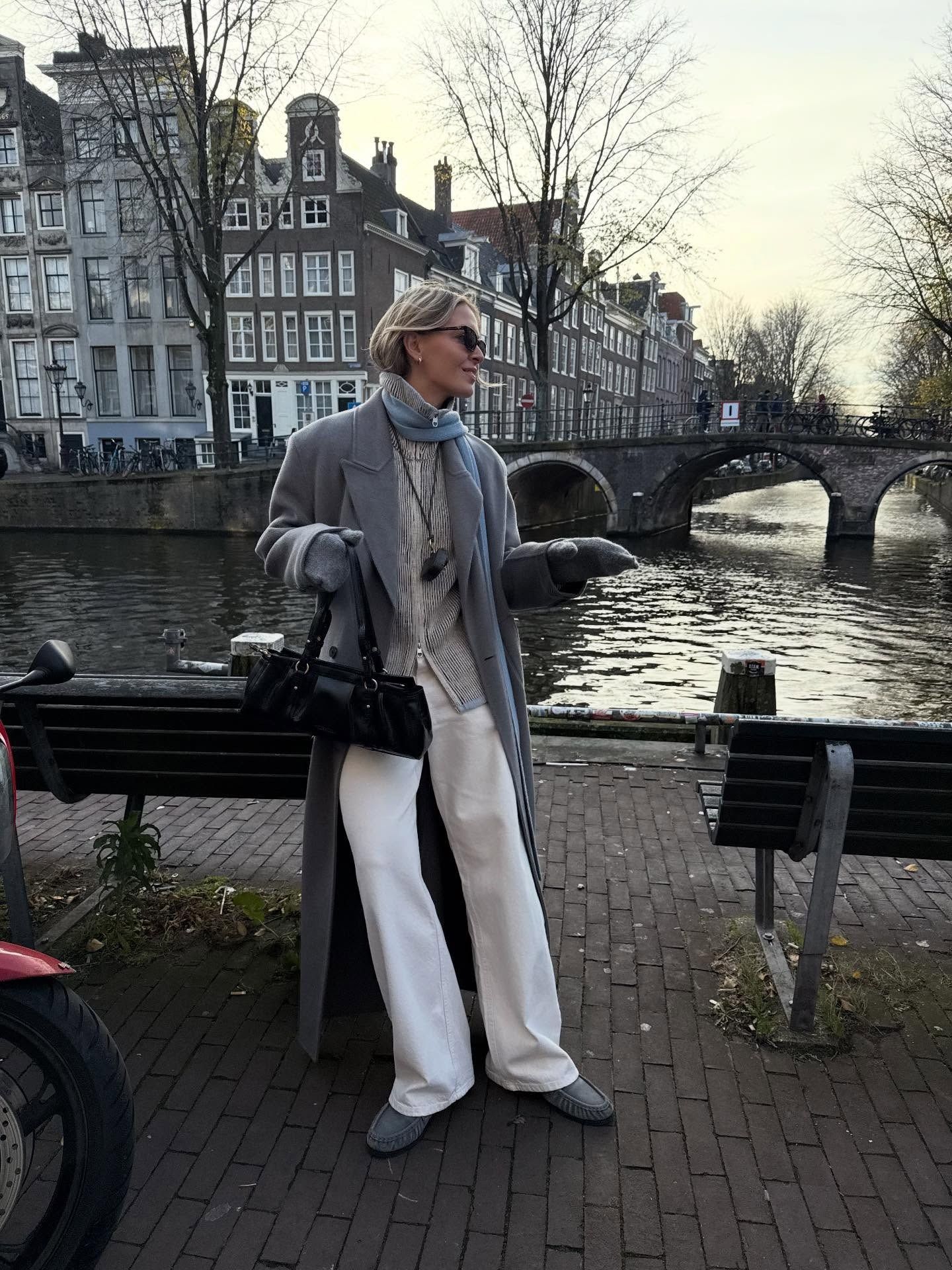 Fashion person Hollie Mercedes wears the zip-up knitted jacket trend. She wears a grey zip up knitted jacket.