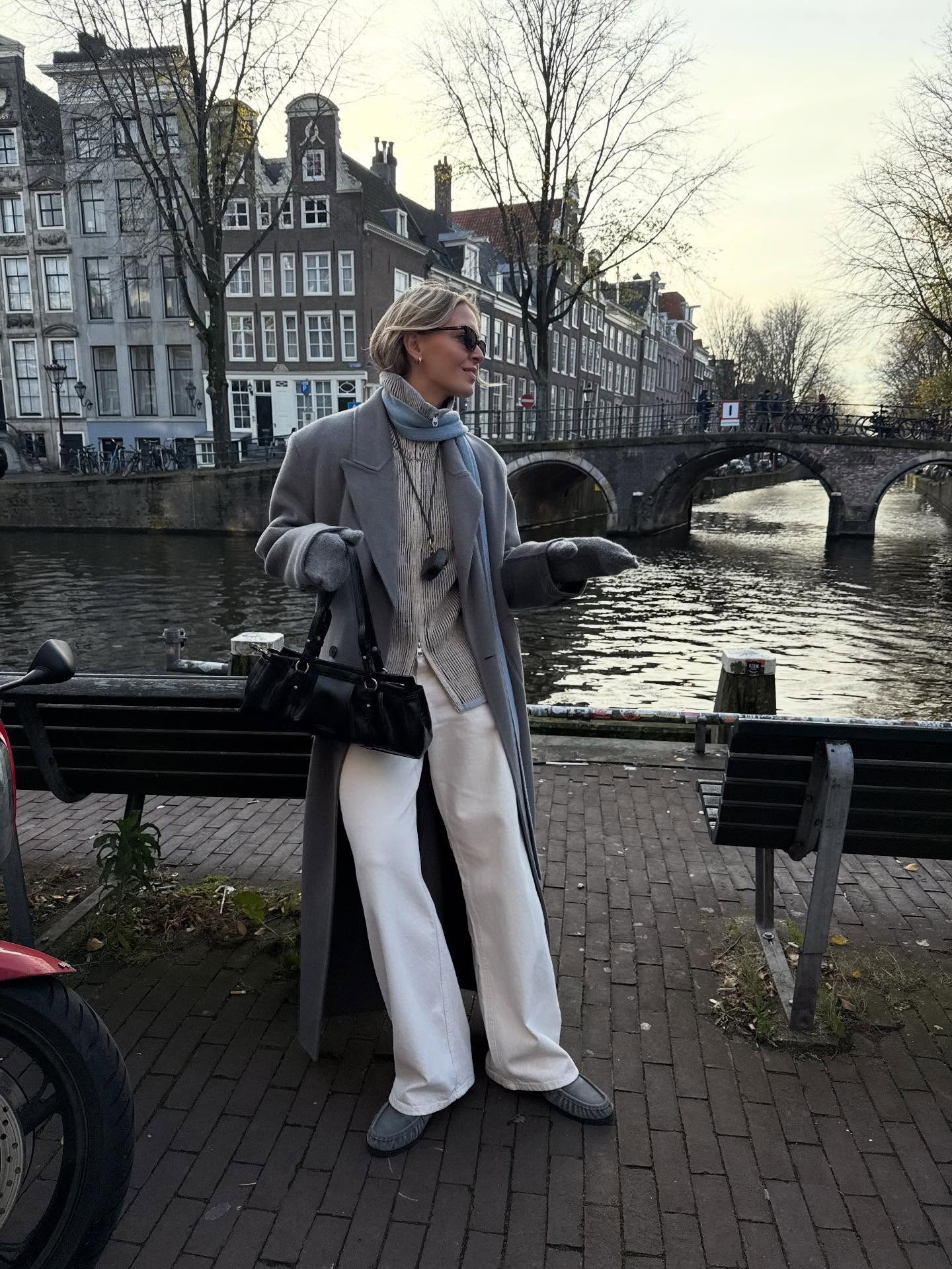 Fashion person Hollie Mercedes wears the zip-up knitted jacket trend. She wears a grey zip up knitted jacket.