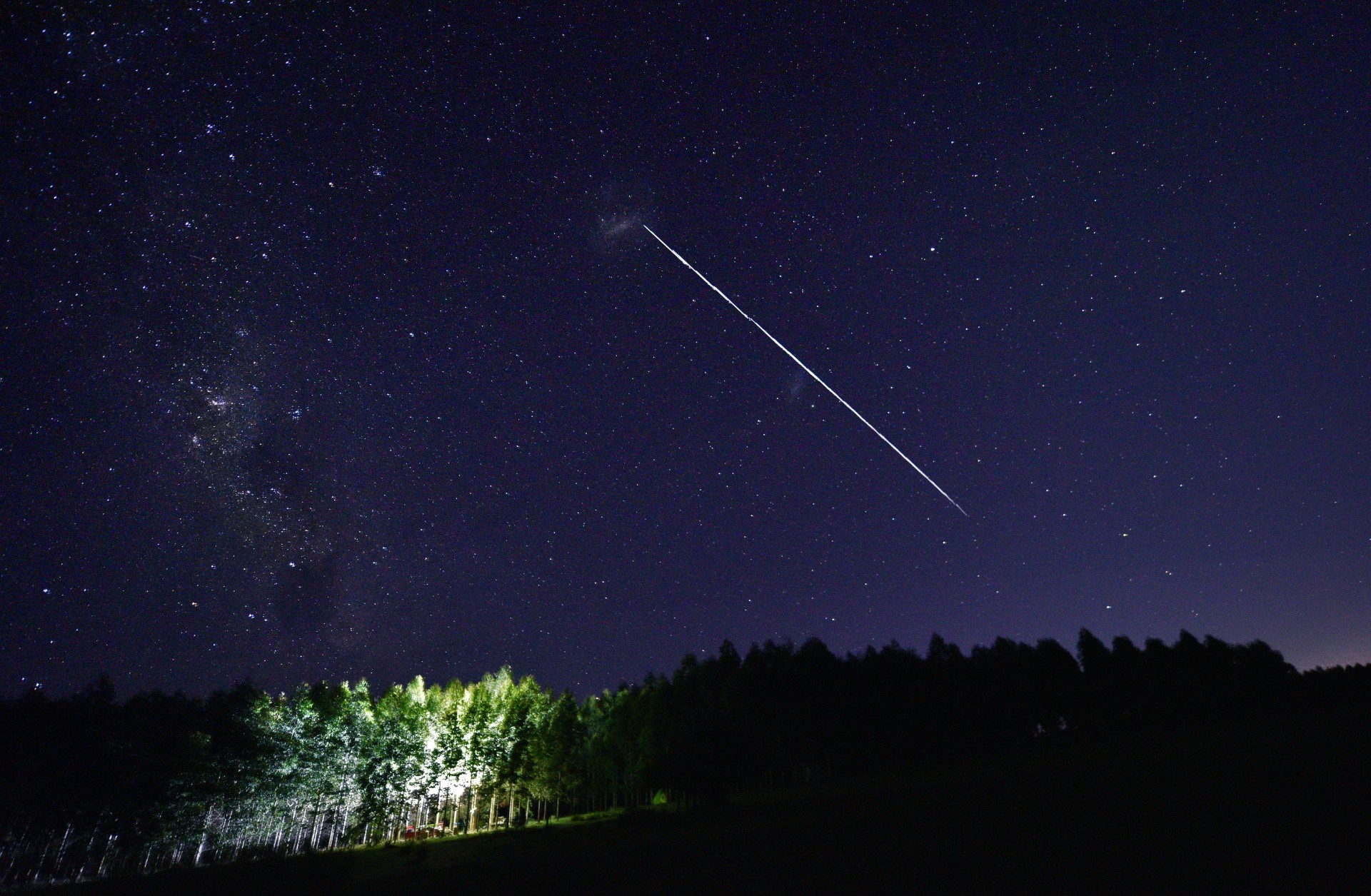 This long-exposure image shows a trail of a group of SpaceX's Starlink satellites passing overhead.