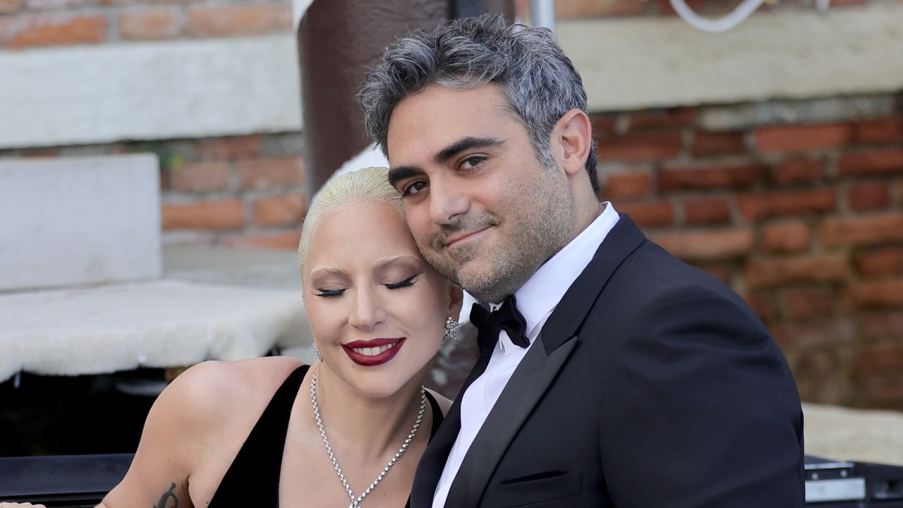 Lady Gaga smiles while hugging fiance Michael Polansky on a boat at the 81st Venice International Film Festival on September 04, 2024