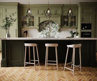 A blue and green kitchen with a botanical tile mural backsplash