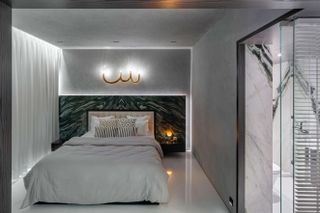 Bedroom with green marble headboard