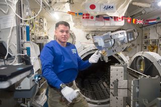 Kimbrough holds the ISS Robotic External Ammonia Leak Locator
