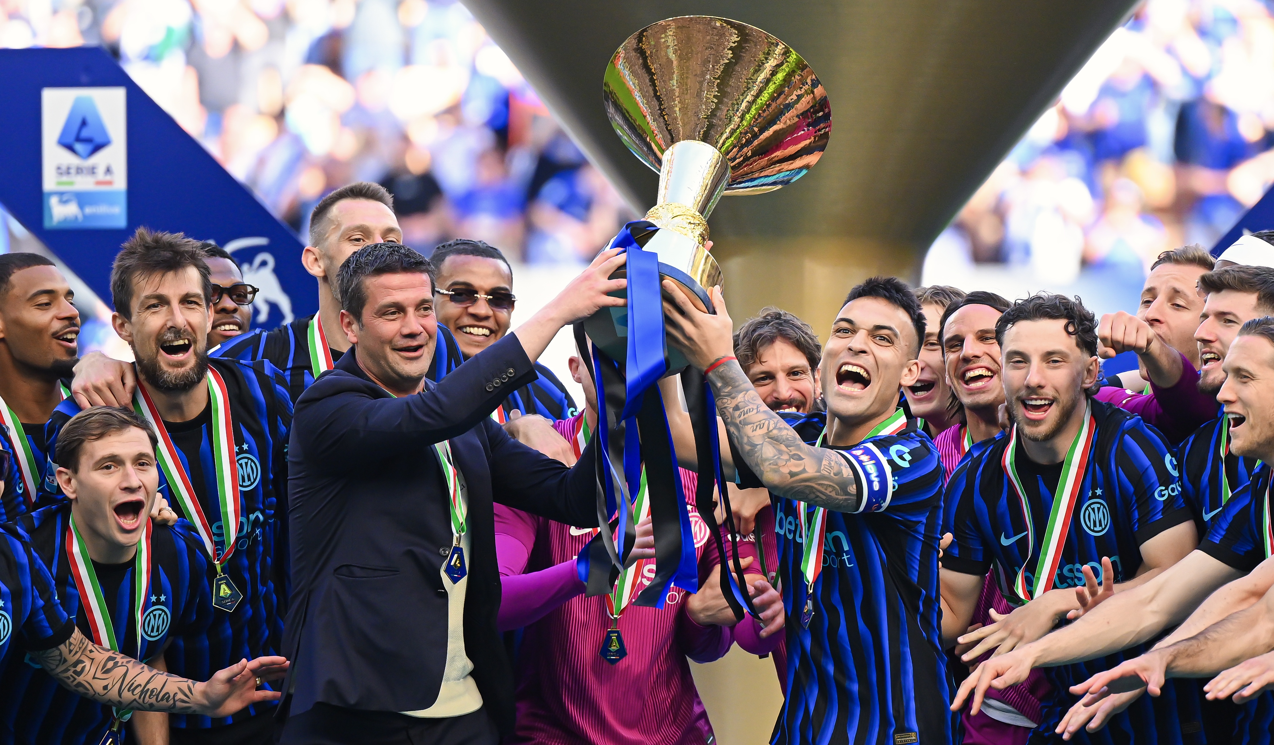 Cristian Chivu and Lautaro Martinez of FC Internazionale lift the Serie A Trophy alongside teammates after the match against Hellas Verona FC at Giuseppe Meazza Stadium on May 17, 2026 in Milan, Italy