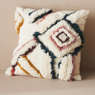 tufted pillow with scandi style pattern in cream and colors