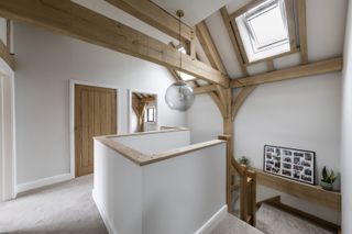 a pendant landing lighting idea in an oak frame home