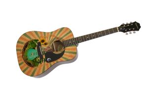 A custom Epiphone DR-100 adorned with the cover of the graphic novel 'Heartstrings'