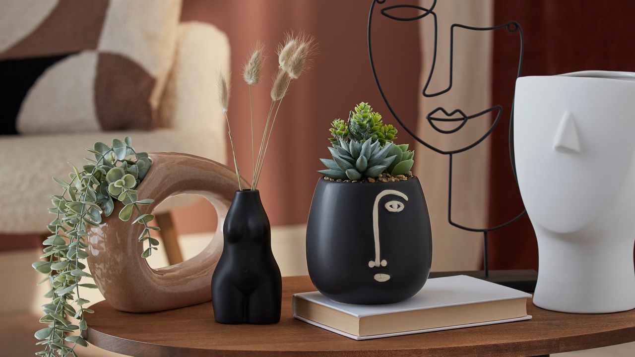 assorted vases in a pink room 