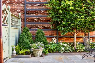 garden patio backyard with flower border by Joseph Richardson of Richardson & Associates Landscape Architecture