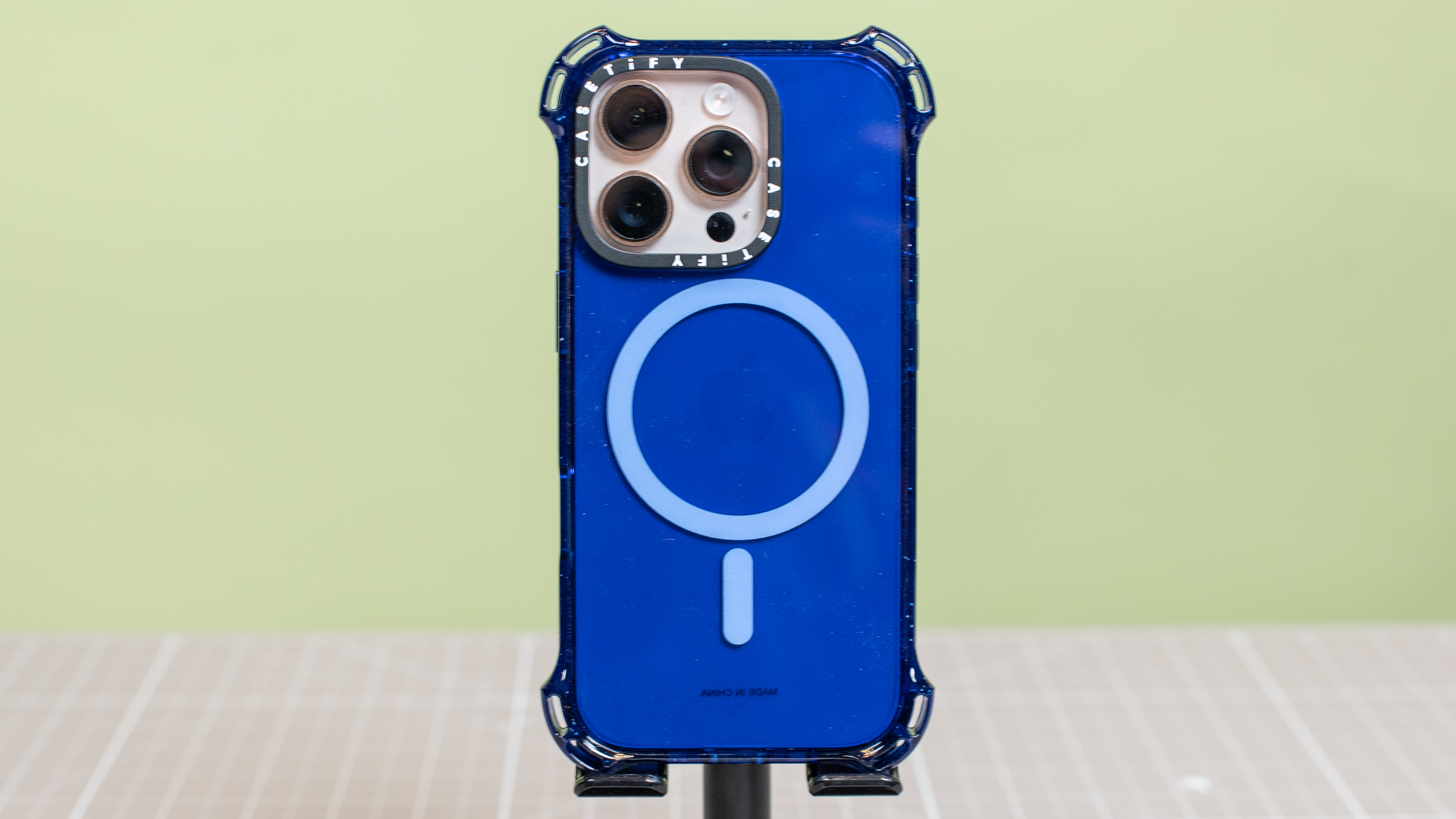 Casetify Bounce from back in blue showing MagSafe magnets and iPhone 16 Pro in desert titanium