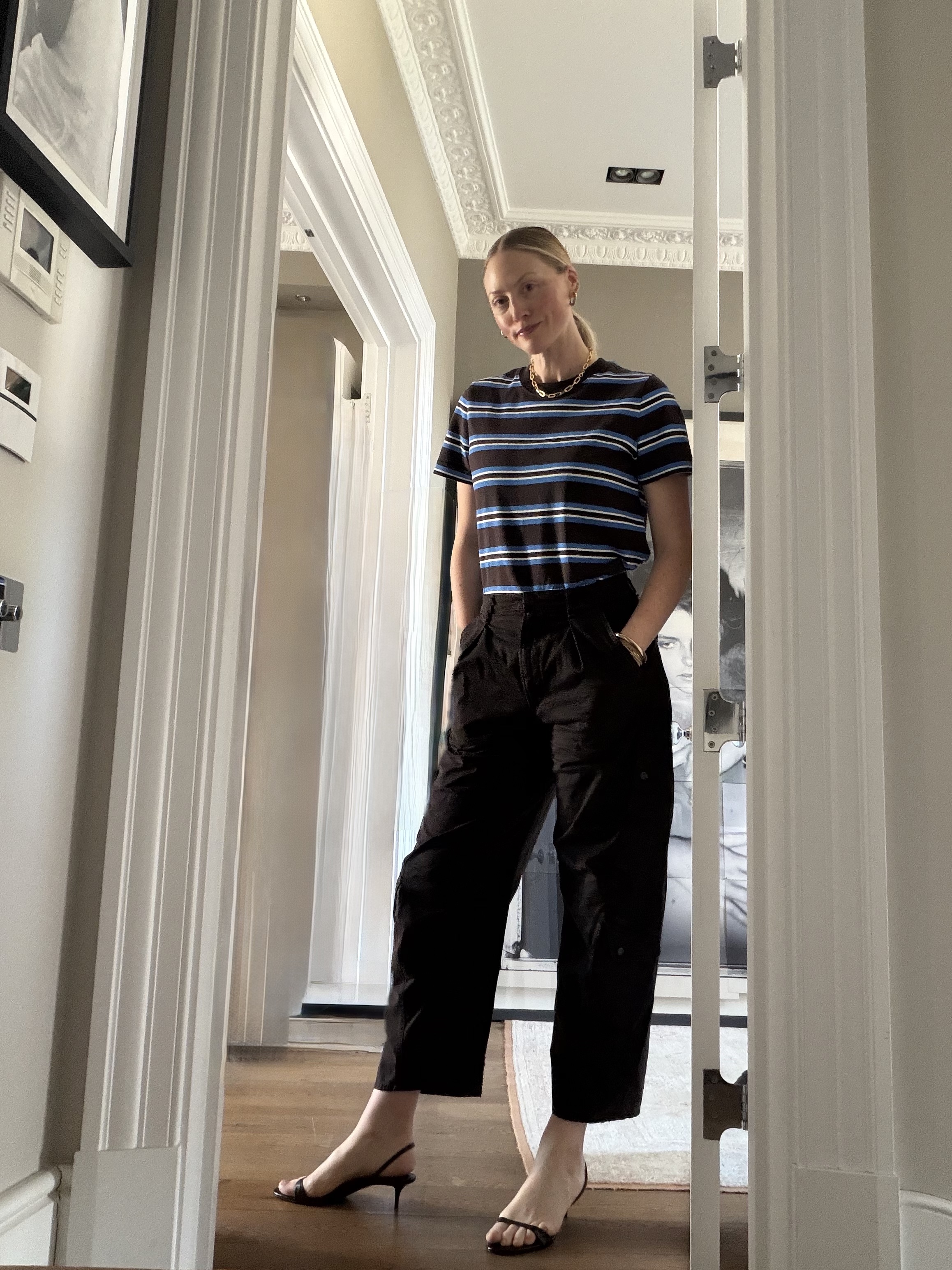 Brooke Ely Danielson styles a slingback kitten heel with a striped top and dark pants