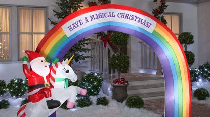'Have a magical Christmas' inflatable with Santa riding unicorn across rainbow