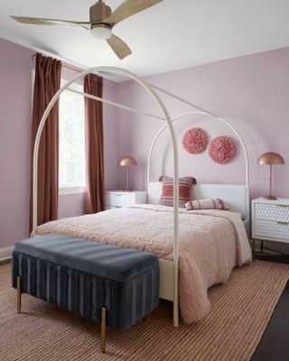 Bedroom with lavender walls and pink bedding, rug and accessories