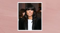 Image of Claudia Winkleman smiling with black shoulder-length straight hair and block fringe, wearing a white T-shirt and black blazer, on a mauve pink background