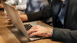 Two People Working on Laptop