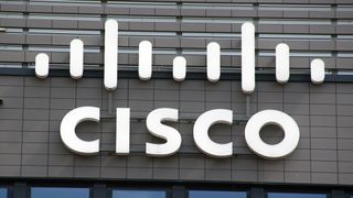 A close up of a grey building with the Cisco logo on it in white