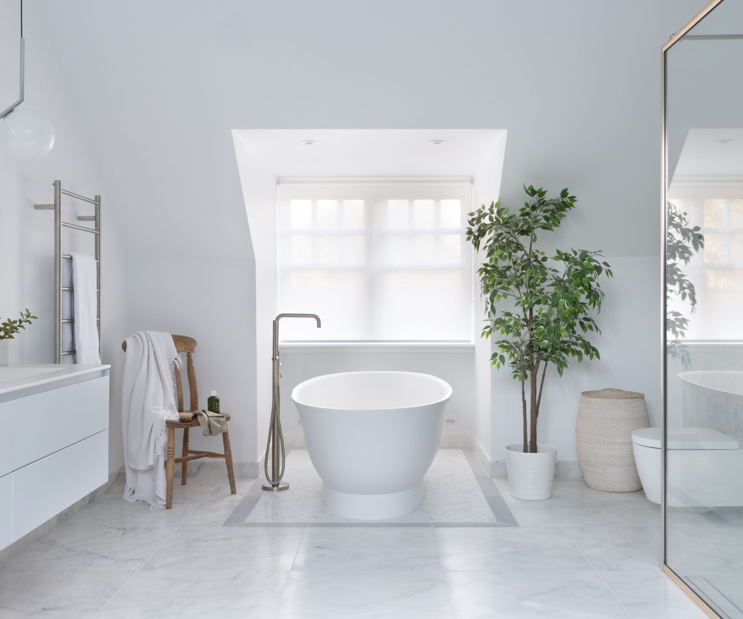 A large white bathroom in the minimalist style