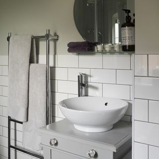 bathroom with wash basin and side table