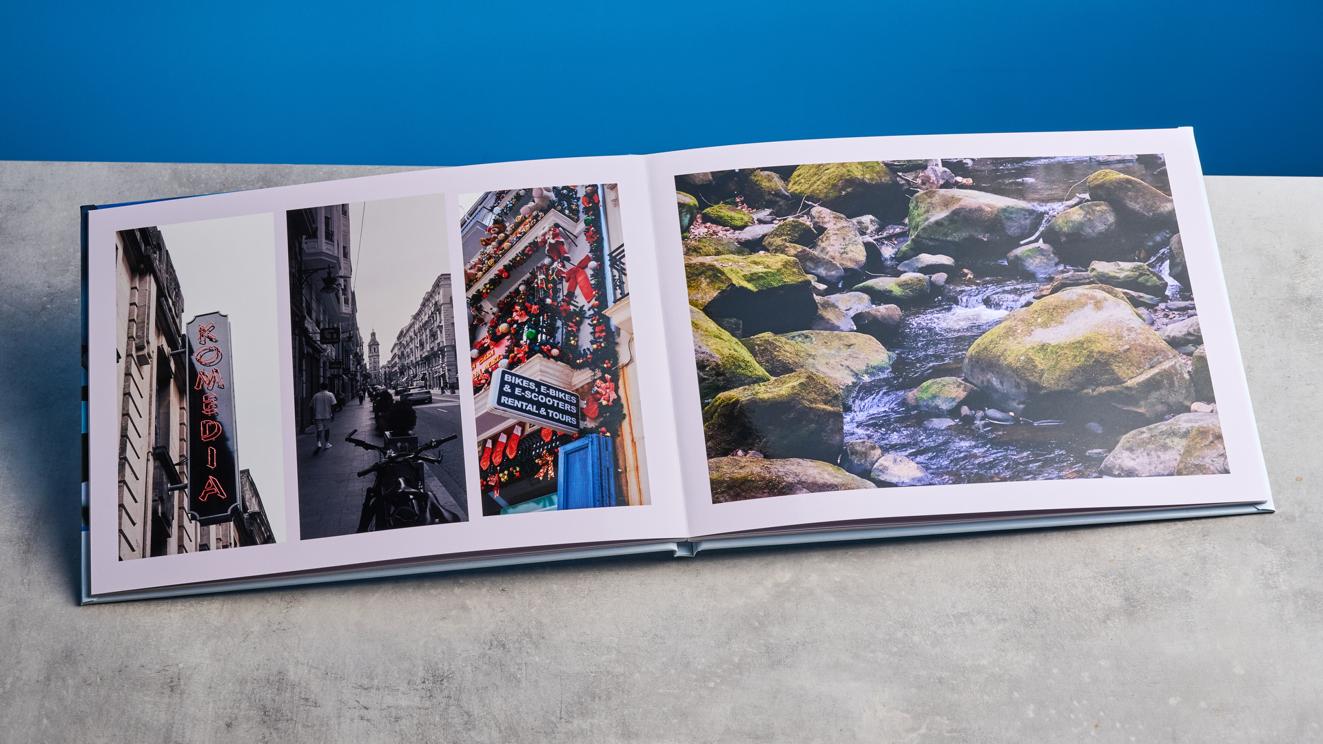 Popsa photo book photographed in front of a blue background