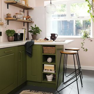 green and pink kitchen with small island