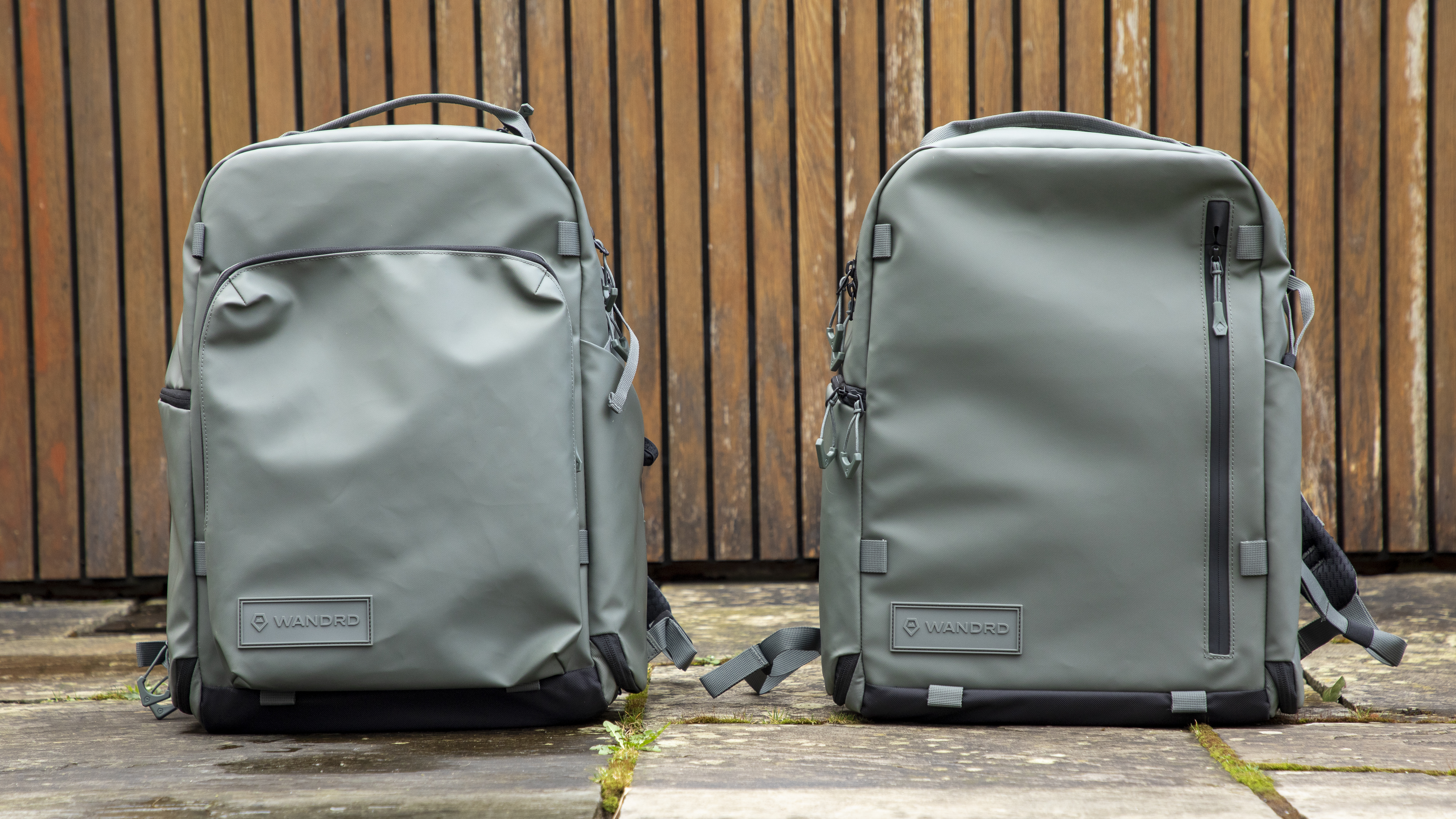 light green camera backpacks against wooden background
