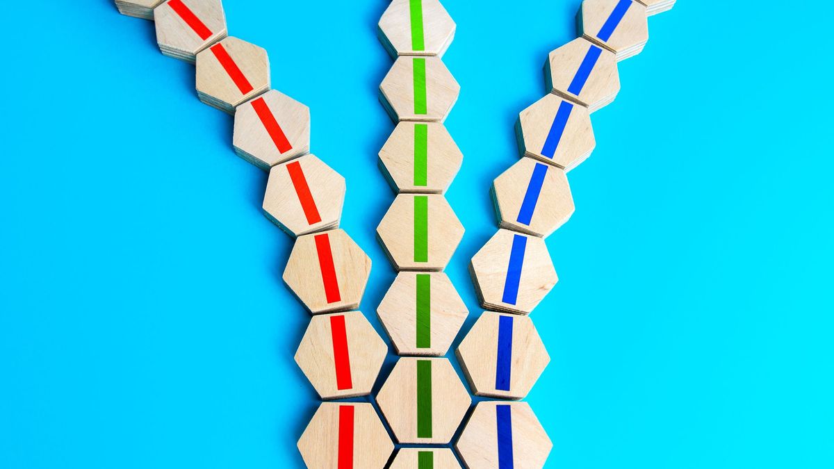 Three lines of wooden hexagonal blocks that diverge into three discrete lines, on a bright blue background