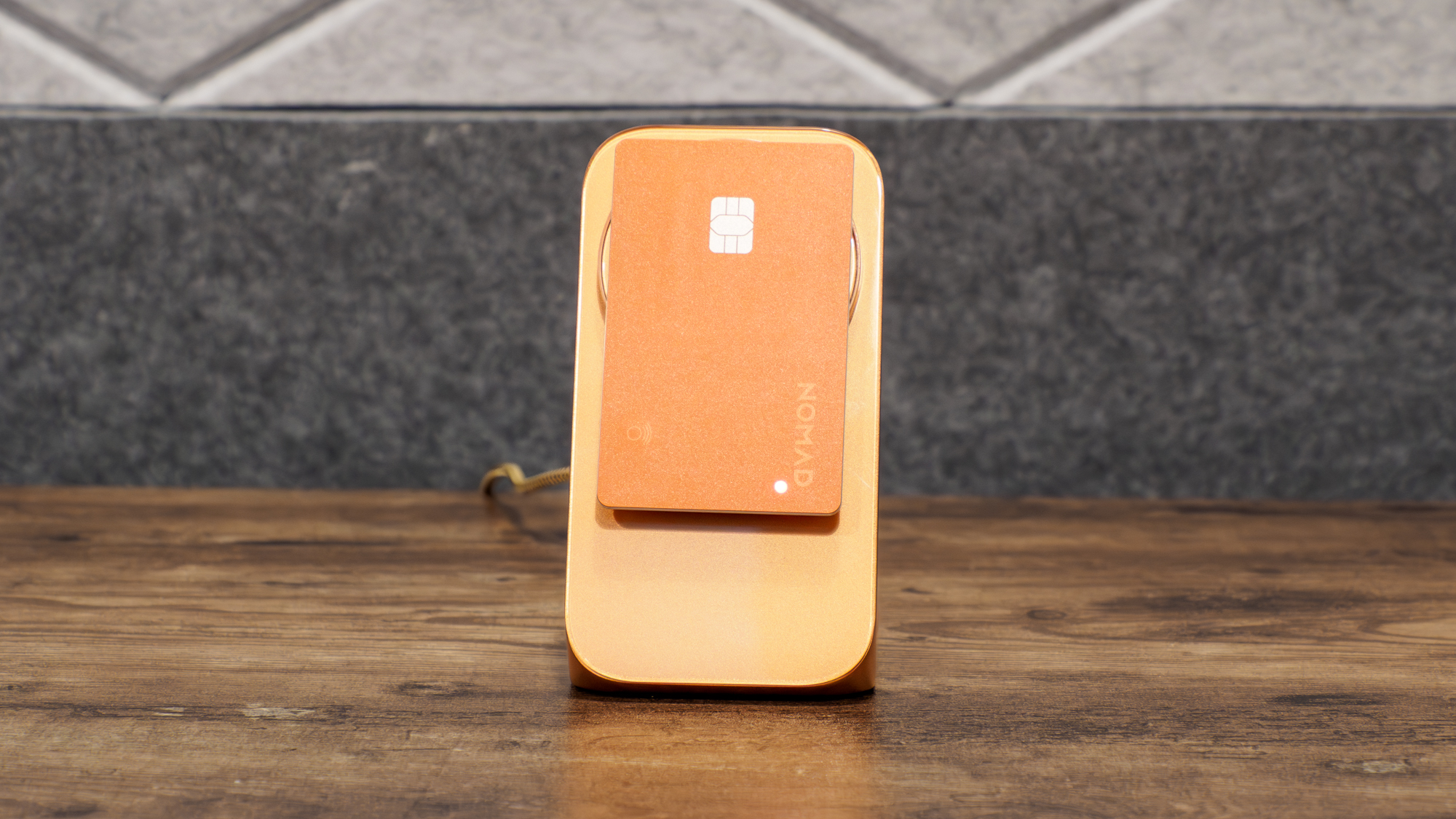 Nomad Tracking Card Pro charging in MagSafe charger.