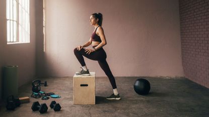 Functional fitness workouts: A woman stretching in a gym with weights