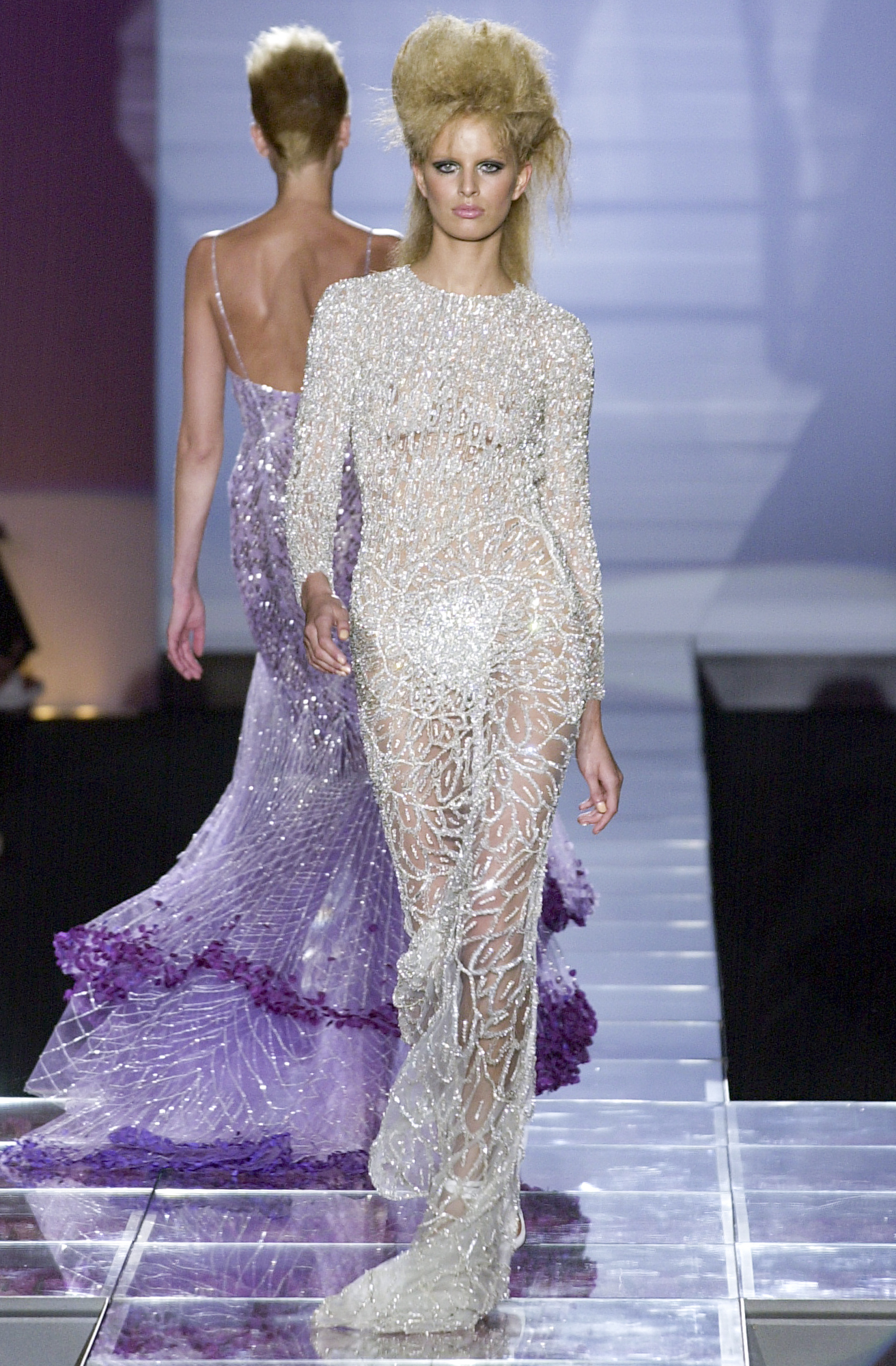 a model wears a crystal-embellished maxi gown