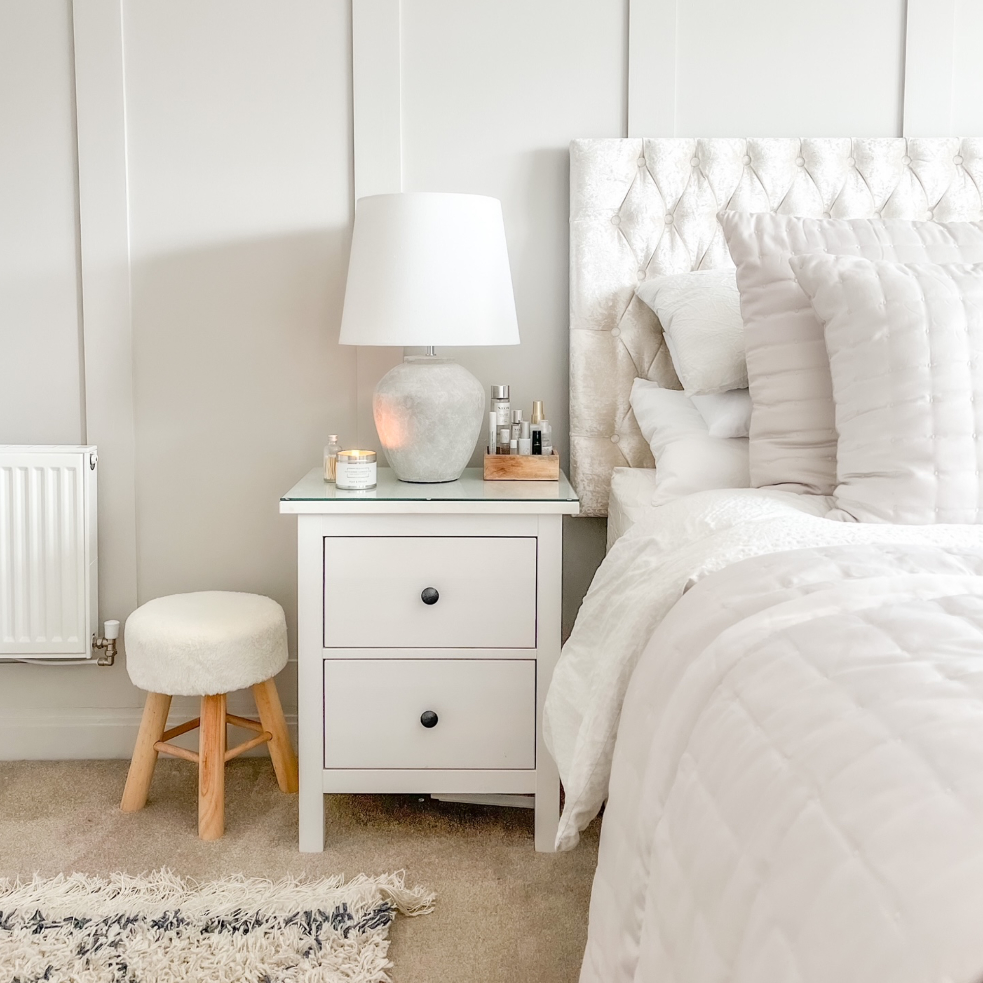 bed with white Ikea bedside table