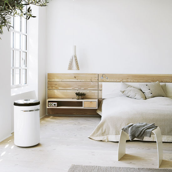 master bedroom with white wall and cushions on bed with white stool