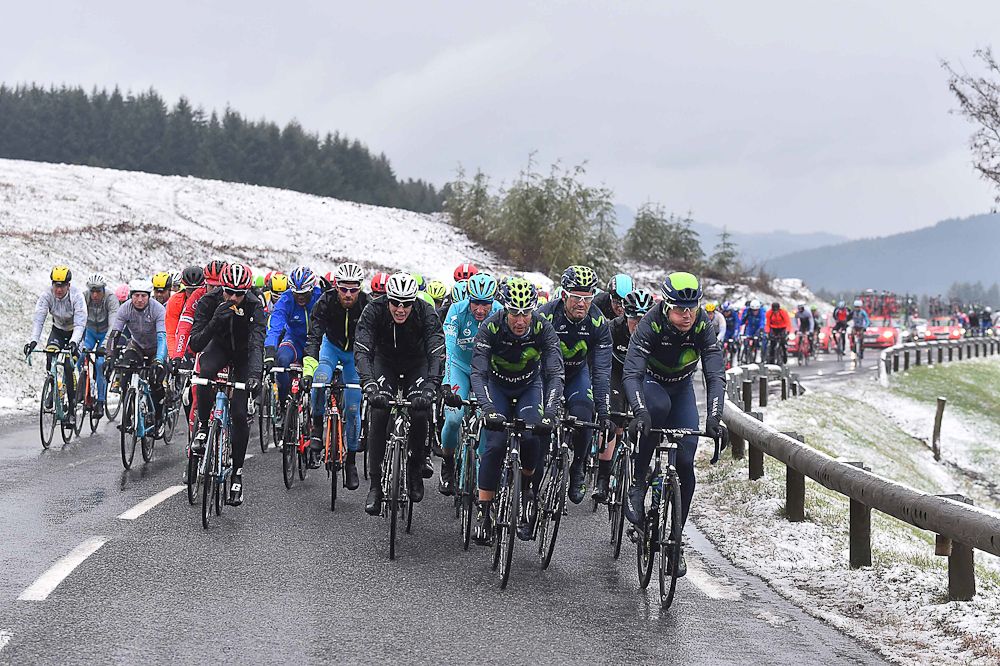 The peloton rides together as the snow falls on Paris-Nice.