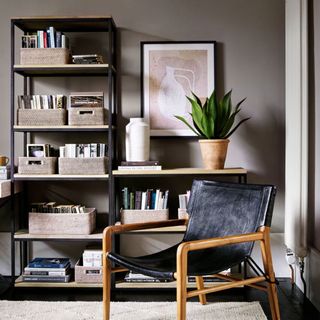 room with black flooring and shelves with books in baskets