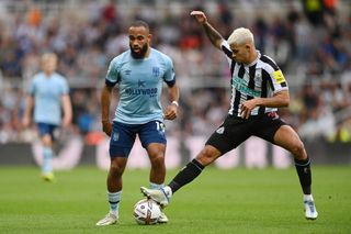 Bryan Mbeumo of Brentford is challenged by Bruno Guimaraes of Newcastle United during the Premier League match between Newcastle United and Brentford FC at St. James Park on October 08, 2022 in Newcastle upon Tyne, England.