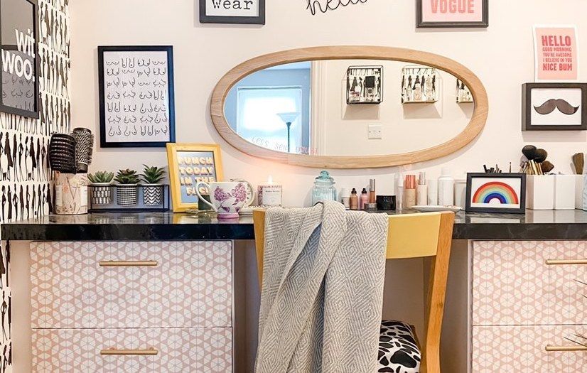 dressing room with patterned drawers, a mirror and a gallery wall above a dressing table 