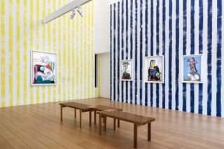Works on display on striped walls at 'Picasso Celebration: The Collection in a New Light!' at Musée Picasso, art directed by Paul Smith