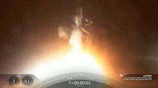 a black-and-white spacex falcon 9 rocket launches at night from california
