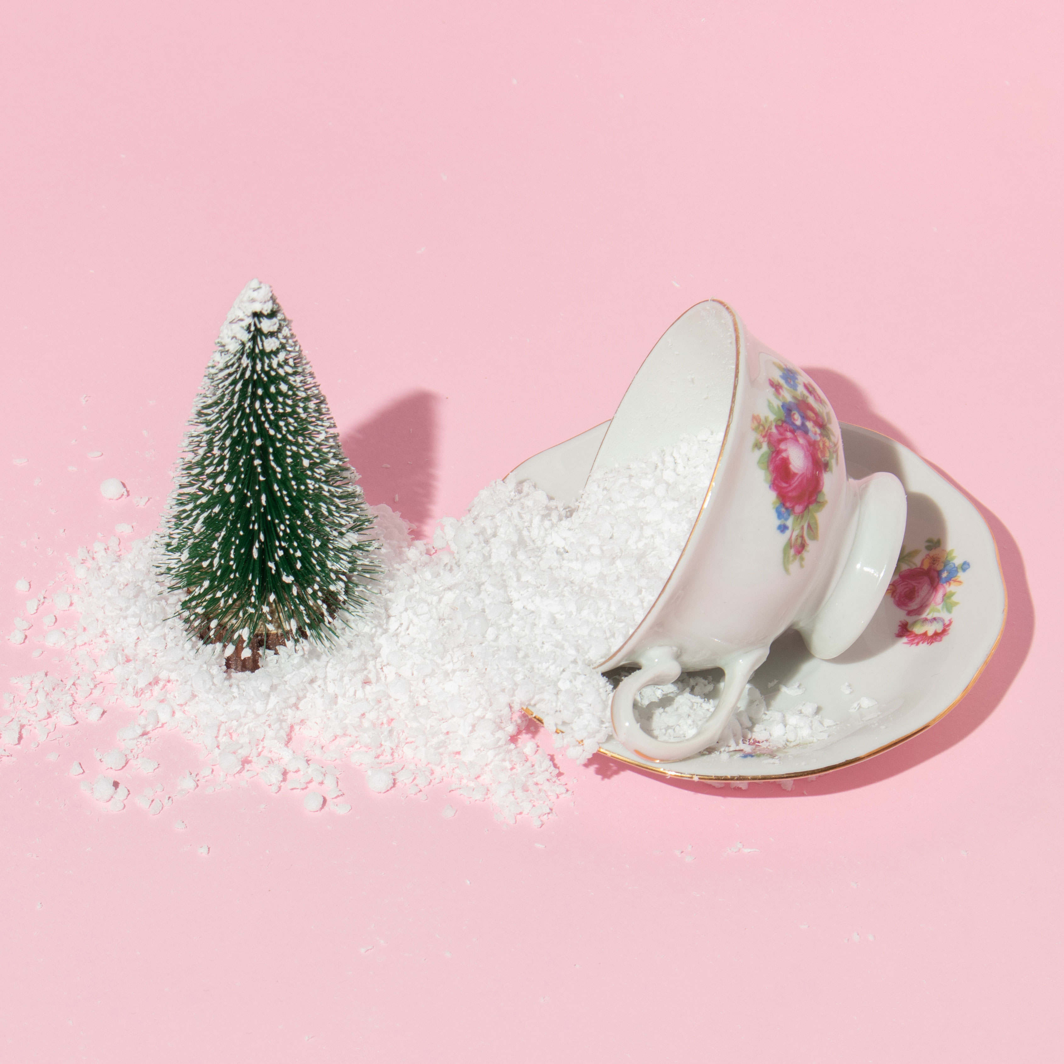 cup of sugar near miniature Christmas tree