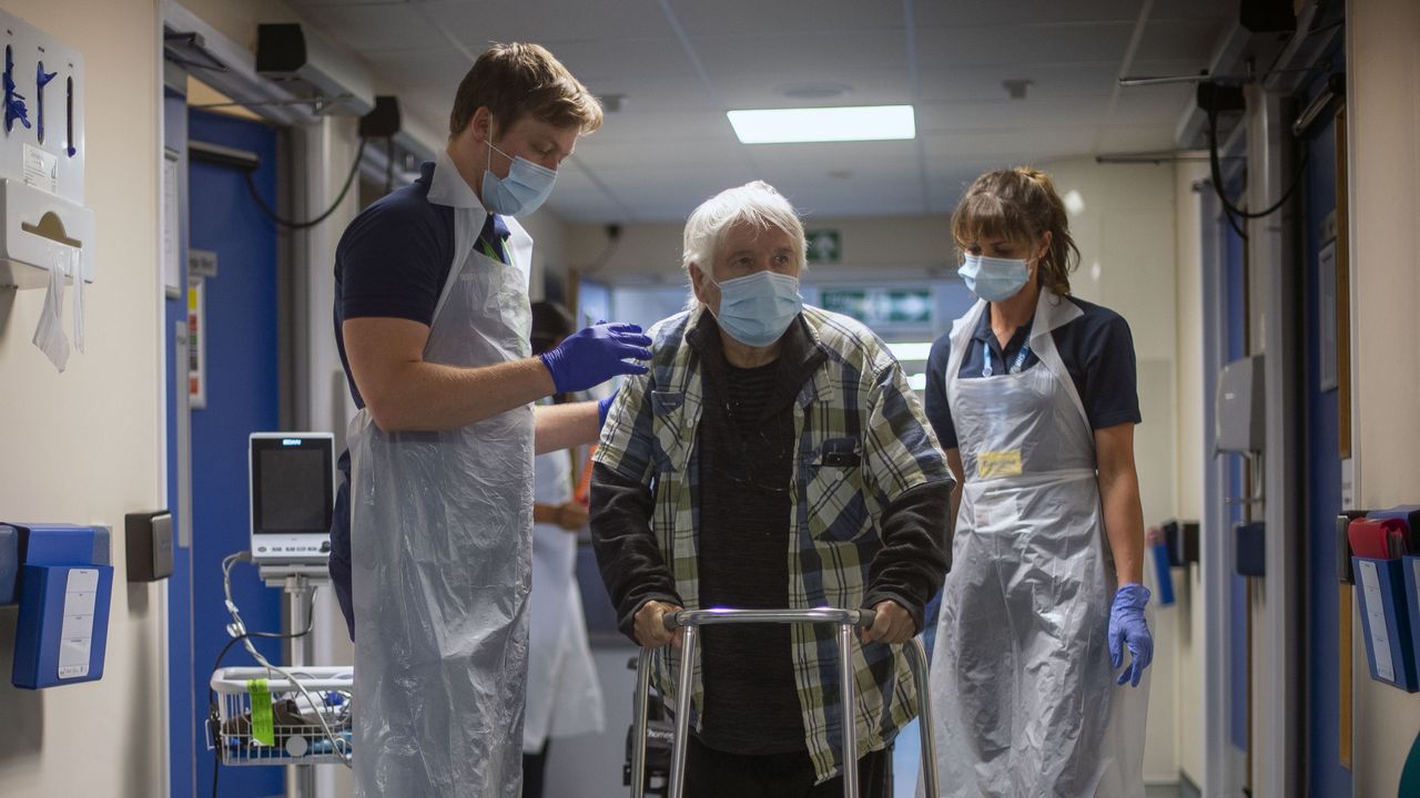 Rehab Support workers help a patient.