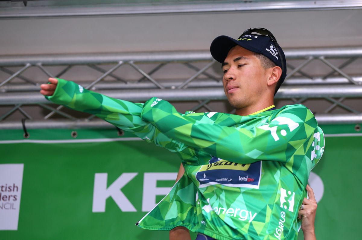 Caleb Ewan pulls on the leader's jersey