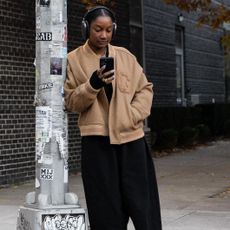Telsha Anderson wearing a tan jacket and black pants in NYC 