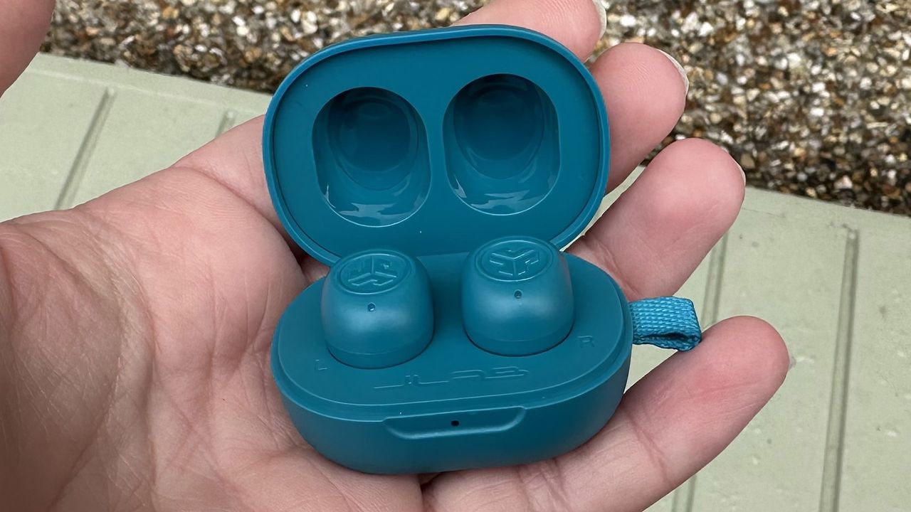 The JLab JBuds Mini being held inside a hand