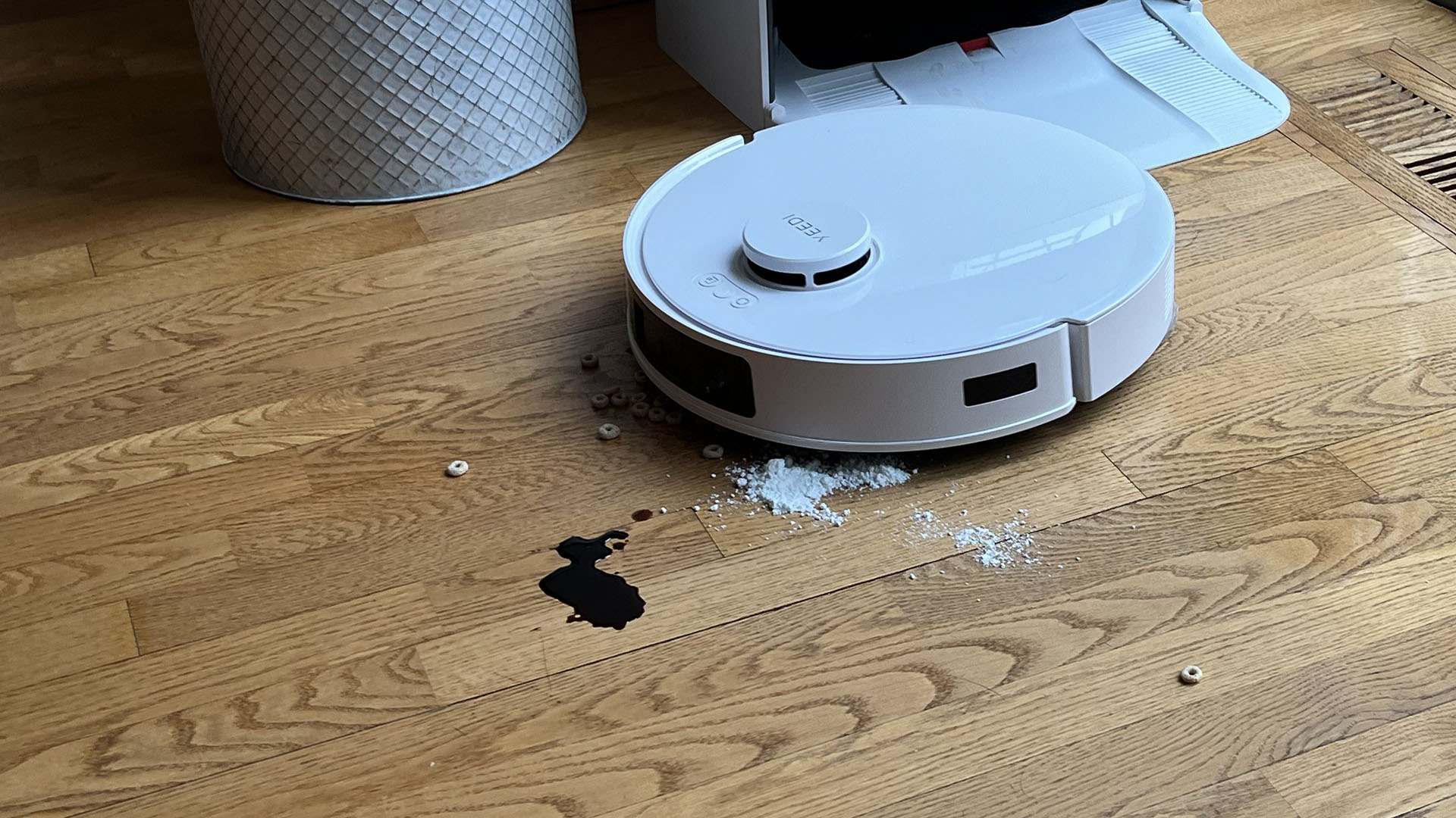 Yeedi M12 Ultra Plus robot vacuum cleaning soy sauce, sugar and cereal from a wooden floor in reviewer's home