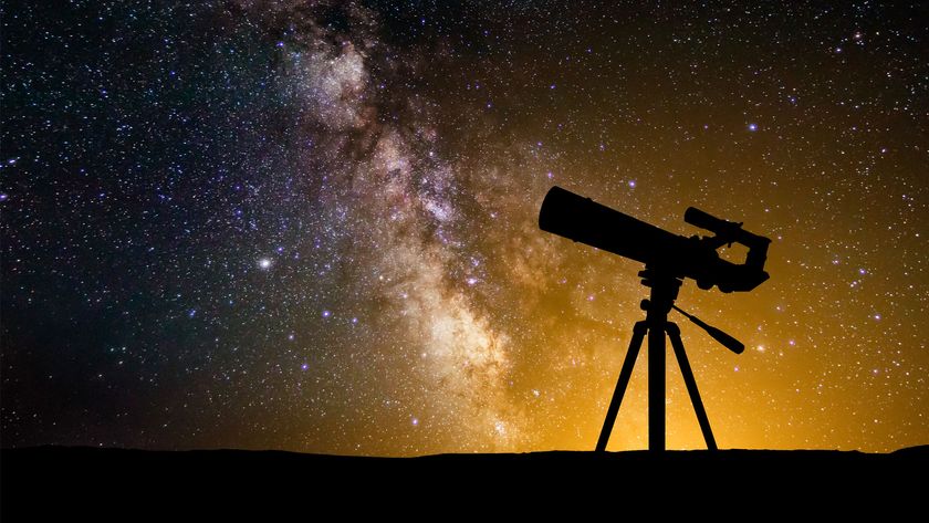 A silhouetted telescope with the backdrop of a night sky.