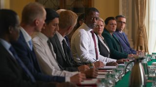 Close up of Prime Minister (Adrian Lester) at a cabinet meeting in a still from The Undeclared War